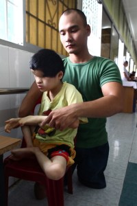 Nguyen Hong Loi and child born without eyes in Agent Orange children's ward at Tu Du Hospital in Ho Chi Minh City, Vietnam